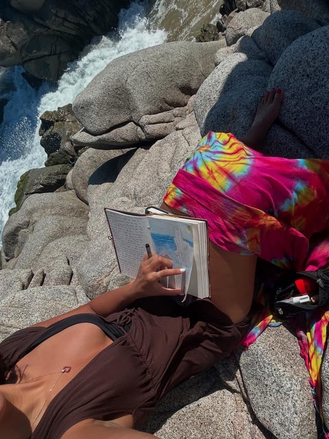 Journaling on rocks by the water